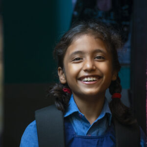 Portrait Of Smiling Girl Standing At Home